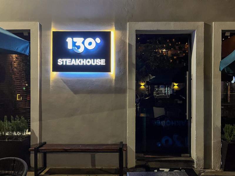 Restaurant entrance with a light-up sign.