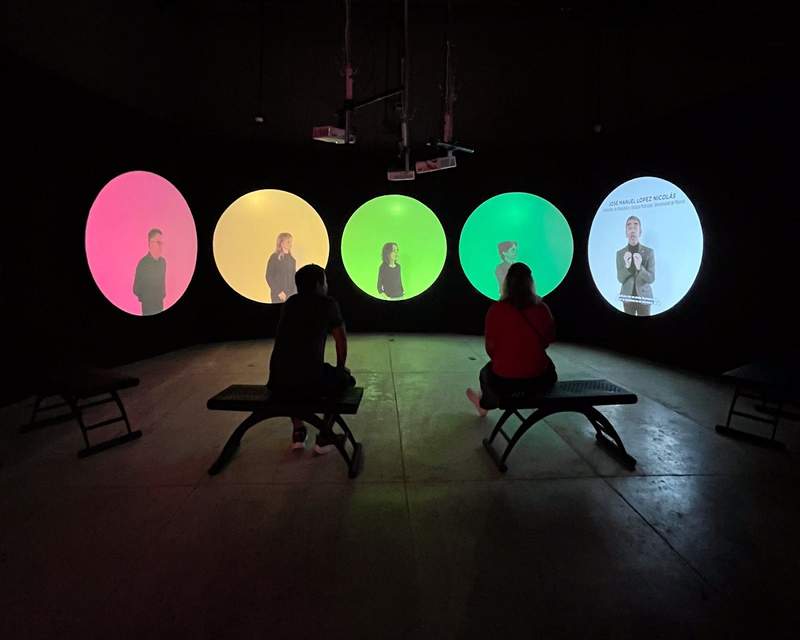 Colorful projections against a black backdrop in the interior of the Museum of Light.