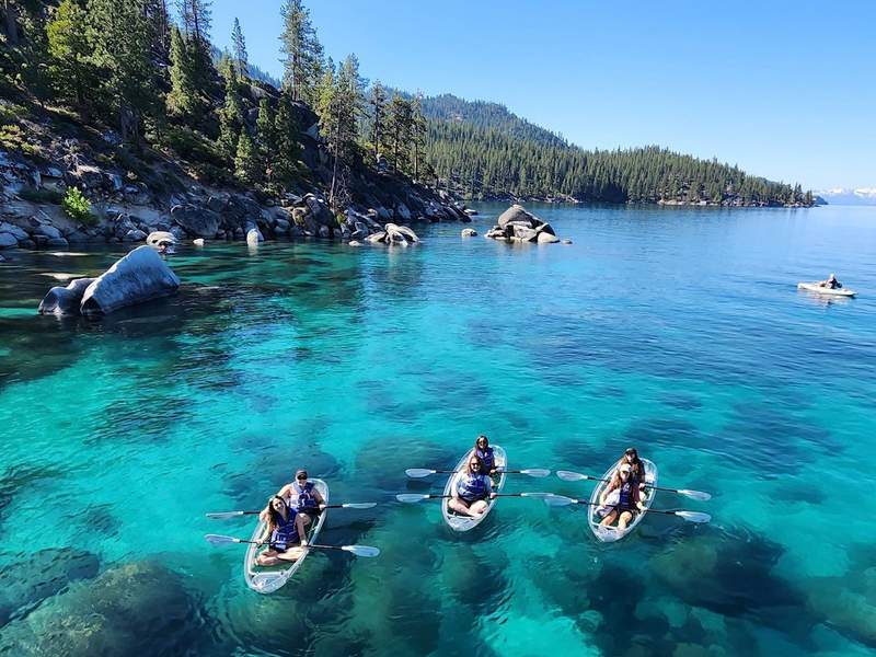 Girls in clear-bottomed kayaks on Lake Tahoe outside of Reno.