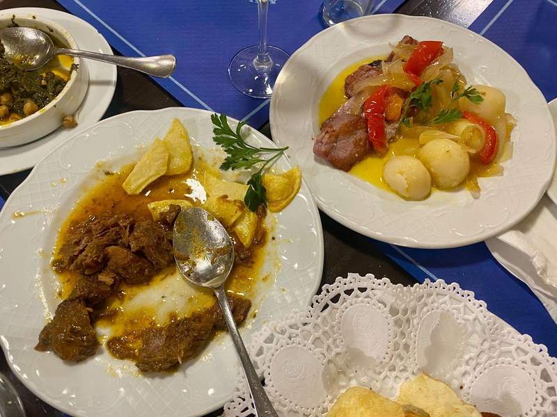 Two plates of food, one meat one fish