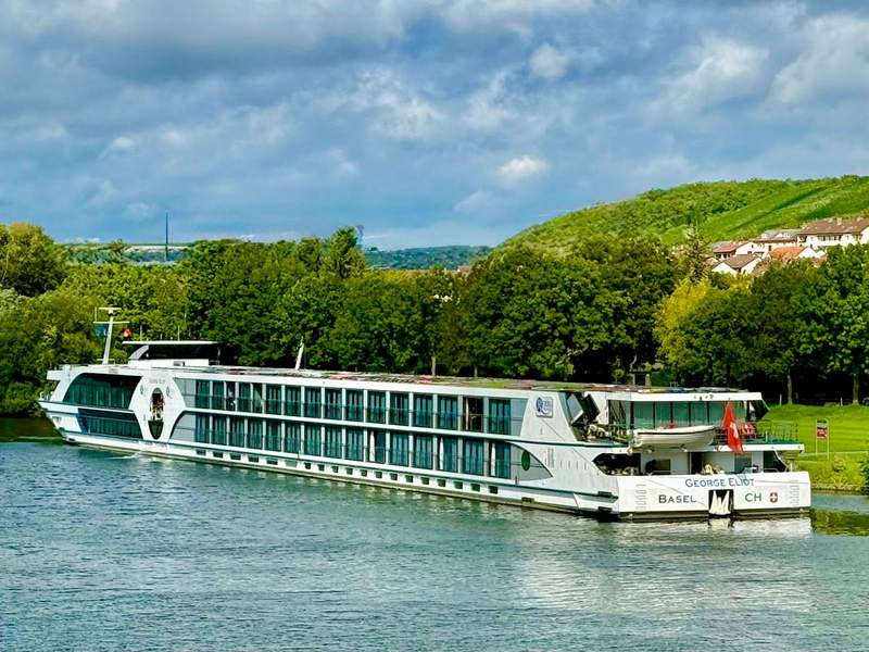 River cruise ship MS George Eliot moored beside the riverbank in Ochsenfurt, Germany.