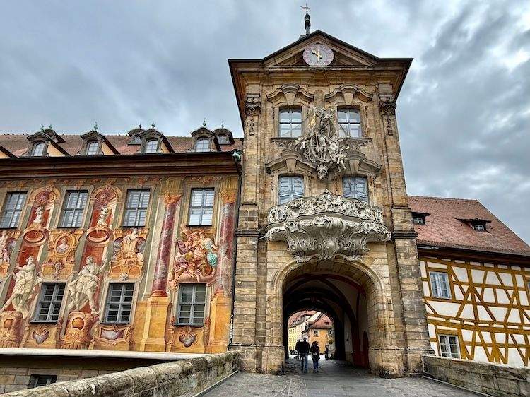 Old City Hall with tall clock tower spanning the Regnitz River in Bamberg, Germany.