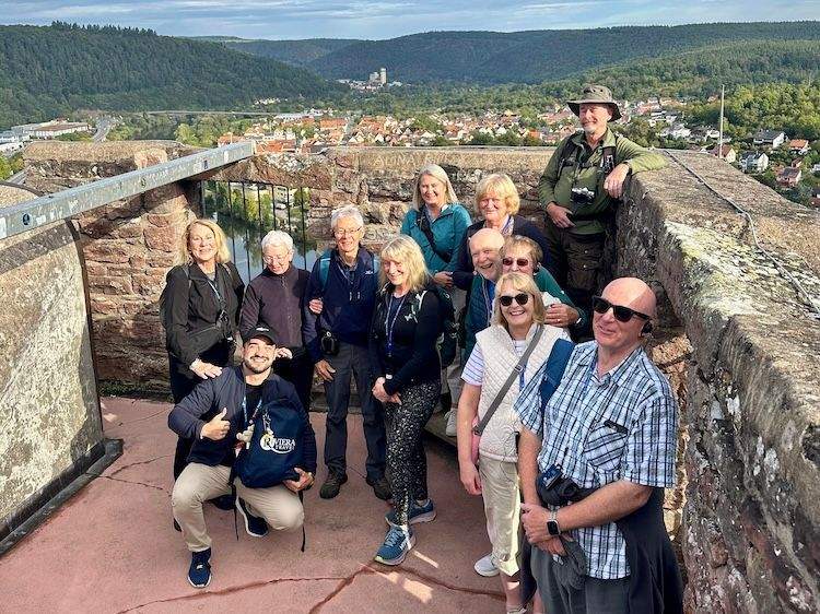 Tour group standing atop the Wertheim Castle ruins, overlooking the Main River and town below.