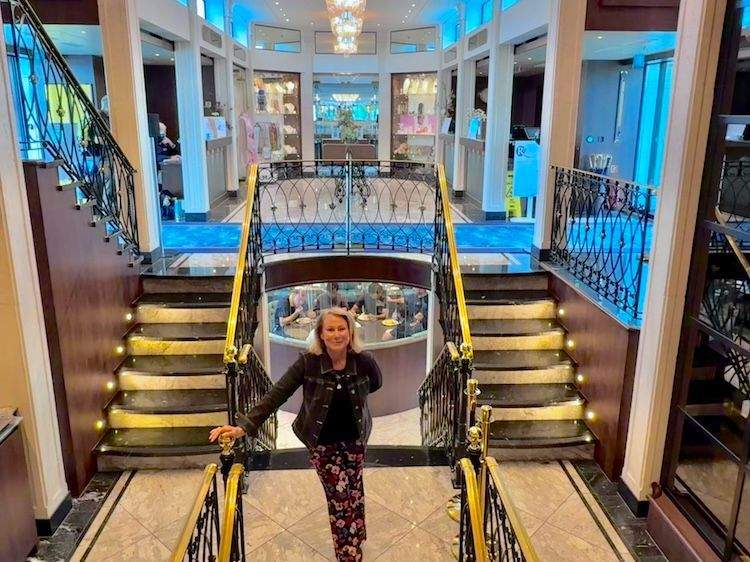 Author Sharon Kurtz standing in the airy, light-filled atrium of the MS George Eliot river cruise ship.