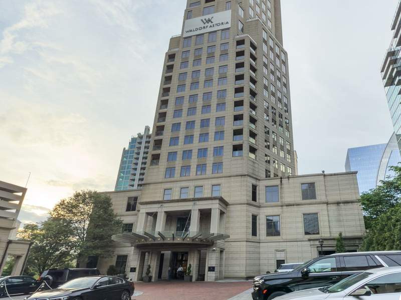 Front entrance of Waldorf Astoria Atlanta Buckhead with stately architecture, covered drive, and landscaped details creating a luxurious arrival experience.