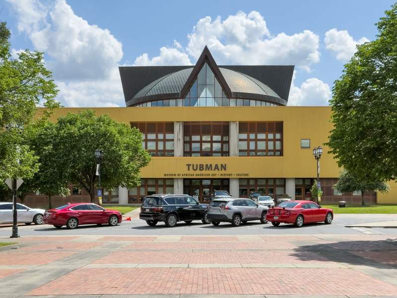 Exterior of the Tubman Museum in Macon, Georgia, featuring modern design with curved walls and glass panels dedicated to African American art, history, and culture.