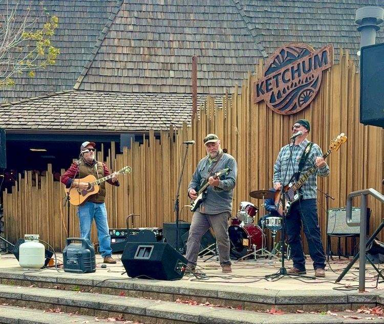 A band performs upbeat music on an outdoor stage as festivalgoers dance and celebrate during the Happy Trails Festival Closing Party in Ketchum, Idaho.