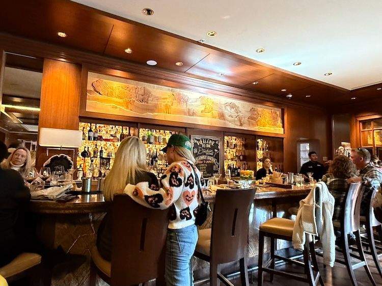 Interior of the Duchin Lounge at Sun Valley Lodge, featuring classic bar seating, warm lighting, and vintage cocktail atmosphere.