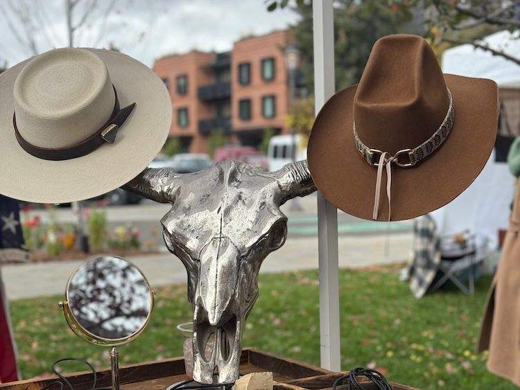 Colorful display of felt cowboy hats arranged on a vendor table at the Happy Trails Festival in Ketchum.