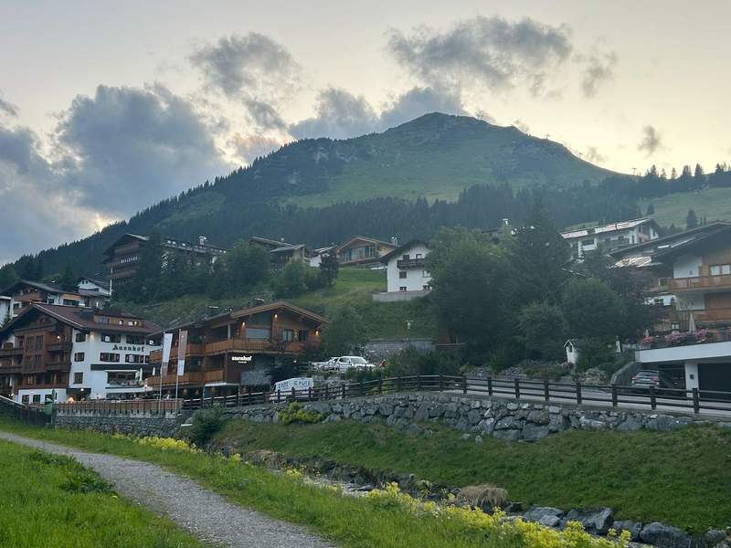 Houses and hotels in the picture-perfect village of Lech set against the mountains of the Austrian Alps. 