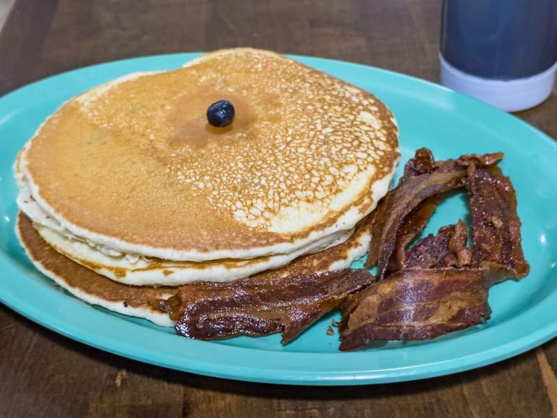 Plate of classic Southern breakfast at Ocracoke Island’s oldest restaurant with U.S. Coast Guard bagpipers dining nearby before the British Cemetery Ceremony.
