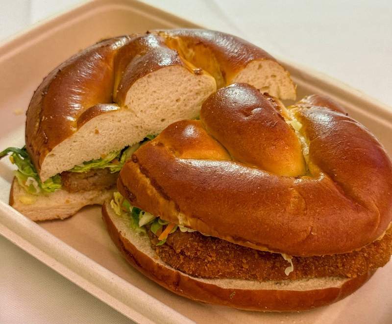 pork schnitzel sandwich on pretzel bun