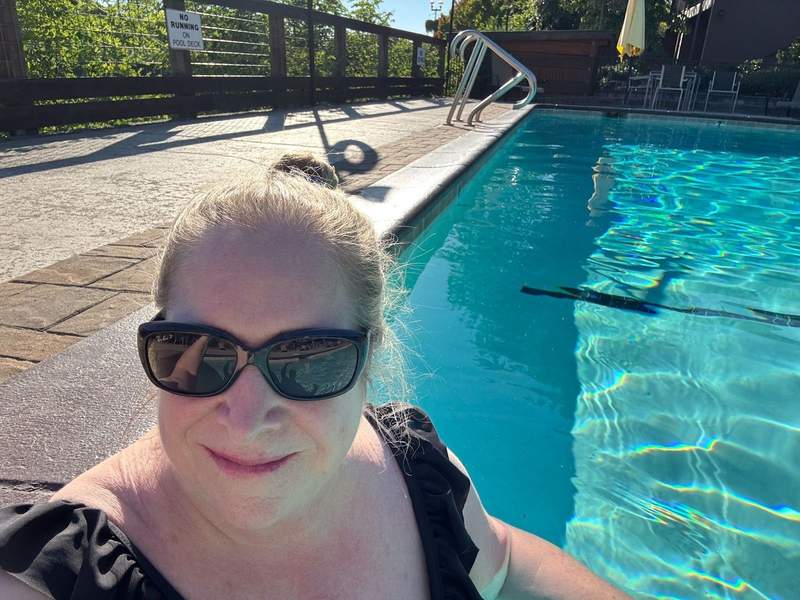 Woman with sunglasses relaxes in a pool in Southern Oregon at the Lodge at Riverside.