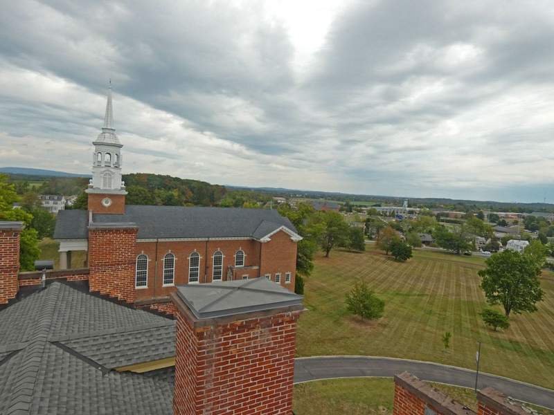 A red brick church in foreground looking down on the town of Gettysburg