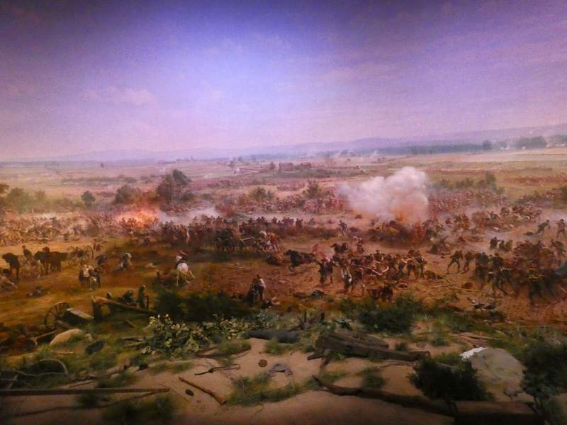 a battle scene with many soldiers and cannons.