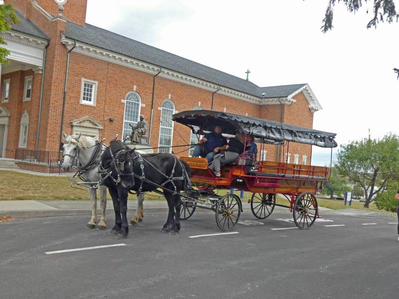 A carriage drawn by a pair of large horses.