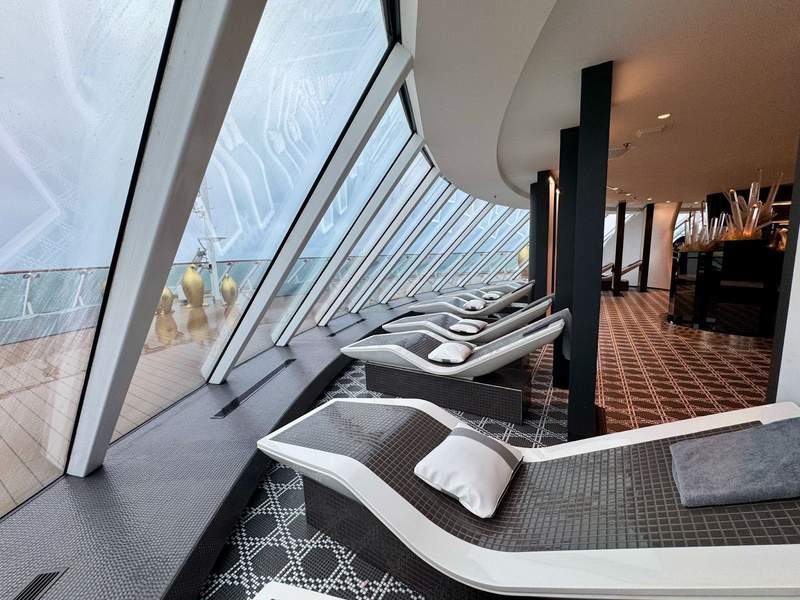 Heated loungers in a row with floor to ceiling windows