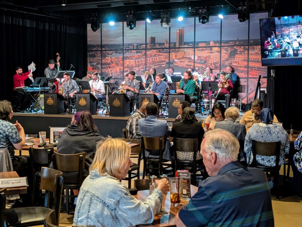 People eating dinner while a big band plays at The Club Room in Fort Wayne Indiana