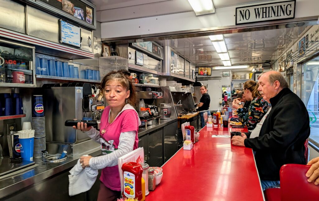 Waitree and a man eating at the counter at Cindy's Diner in Fort Wayne Indiana.