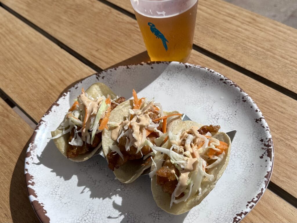 Plate of three fish tacos and a beer at the License to Chill bar and grill at Margaritaville Island Reserve Riviera Maya