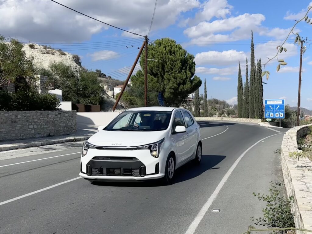 White car traveling in the left lane on a Cyprus road.