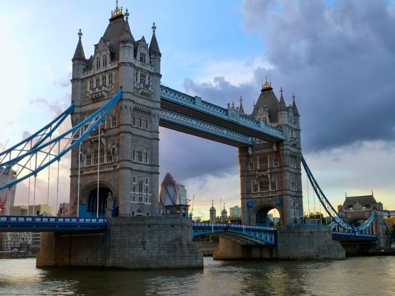 The Tower Bridge, names for nearby Tower of London spans the Thames River the City of London with the South Bank of Greater London.
