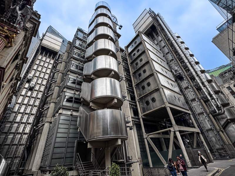 A veritable collision of exposed duct work, pipes and staircases defines the very modern Lloyds Building, known as the Inside-Out Building next to the historic Leadenhall Market in the City of London.