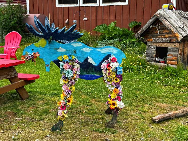 Moose built from wood and decorated with colorful flowers 
