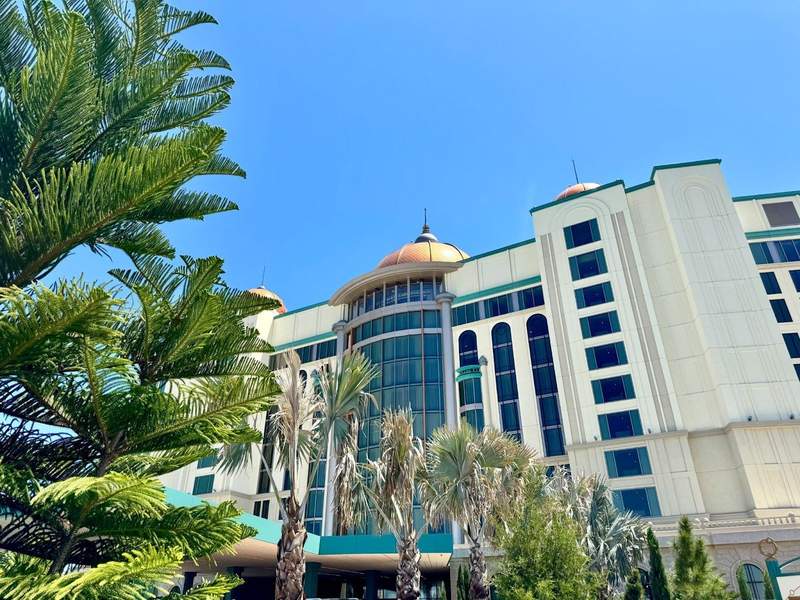 Hotel exterior with trees in the foreground.