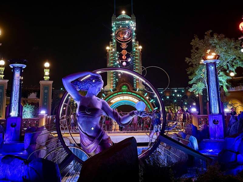 A theme park lit up at night