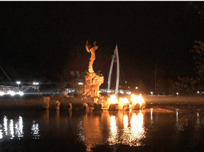 Keeper of the Plains at night with firepots burning. 