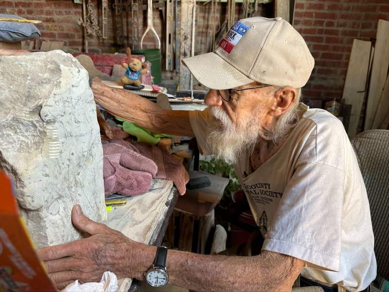 Sculptor Pete Felten, working on a piece of limestone along the Kansas Gunsmoke Trail