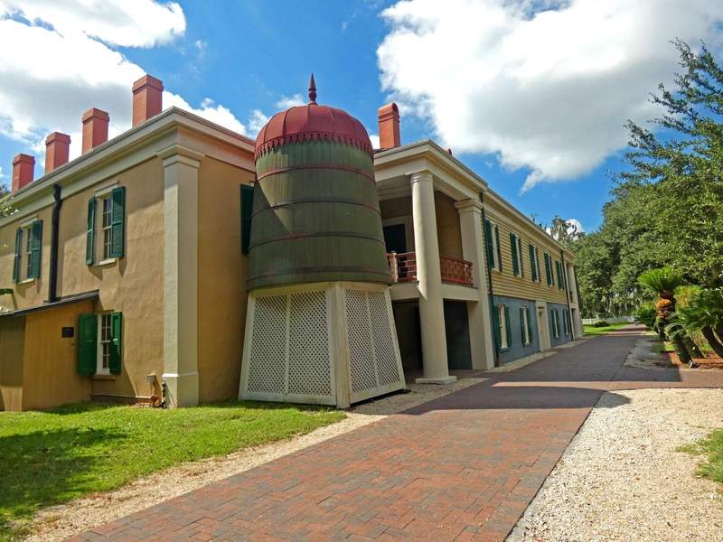 Rear of a plantation home with a water tank.