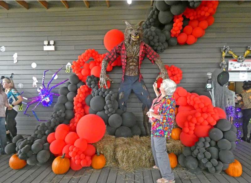 Statue of a Rougarou (Cajun Werewolf) appears to threaten a frightened woman.