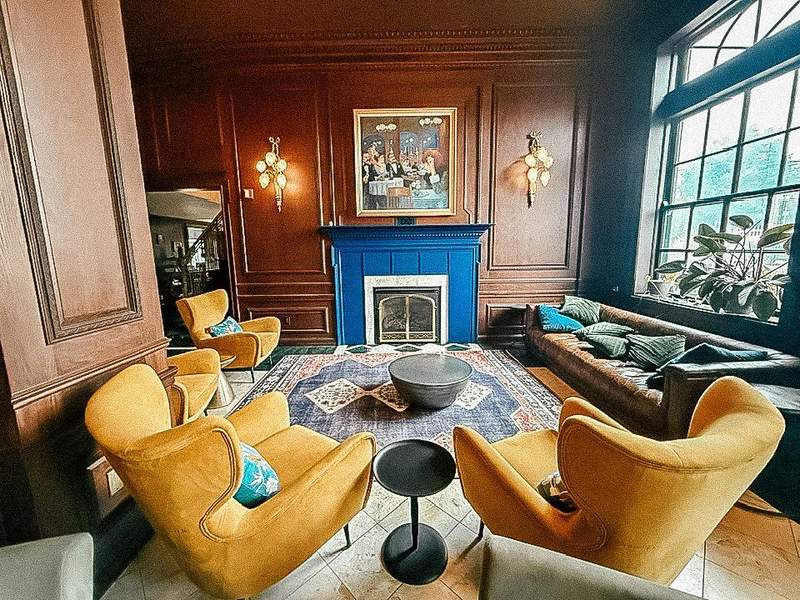 hotel lobby with fold chairs and blue fireplace