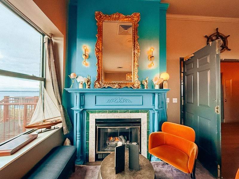 Rooftop bar with teal fireplace and orange velvet chairs