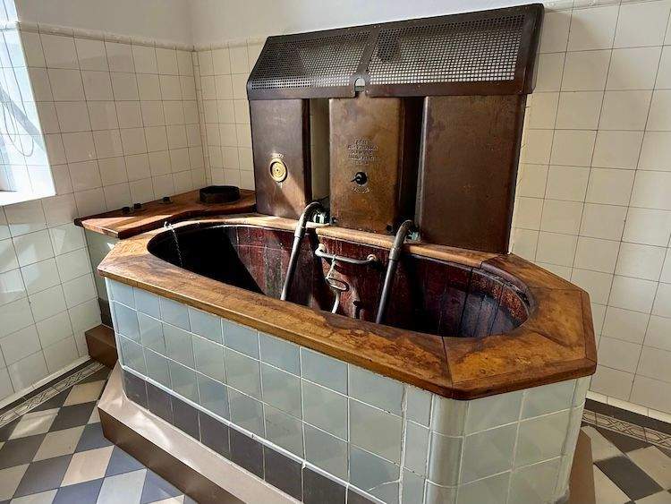 Wooden soaking tub inside a historic spa bathhouse in Bad Kissingen, Germany, highlighting traditional bathing practices.