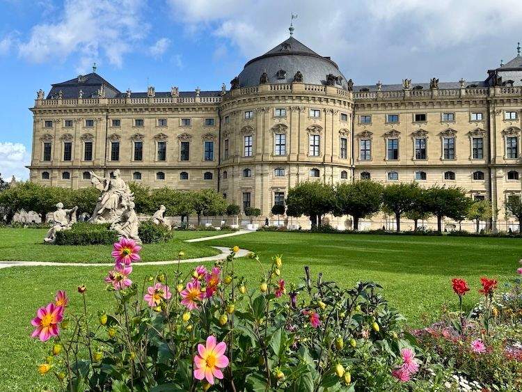 Exterior view of the rear of Würzburg Residenz, featuring formal gardens, sculptures, and the palace’s Baroque architecture.