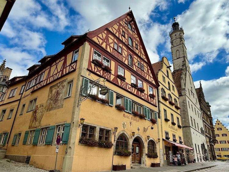 Street view of Rothenburg ob der Tauber with medieval half-timbered buildings and cobblestone streets.