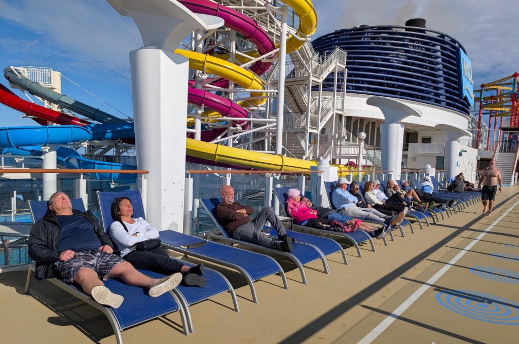 People lounging on the sun deak of the Norwegian Breakaway