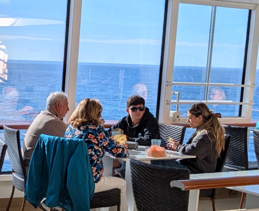 A fmaily playing cards on the Norwegian Breakaway cruise ship