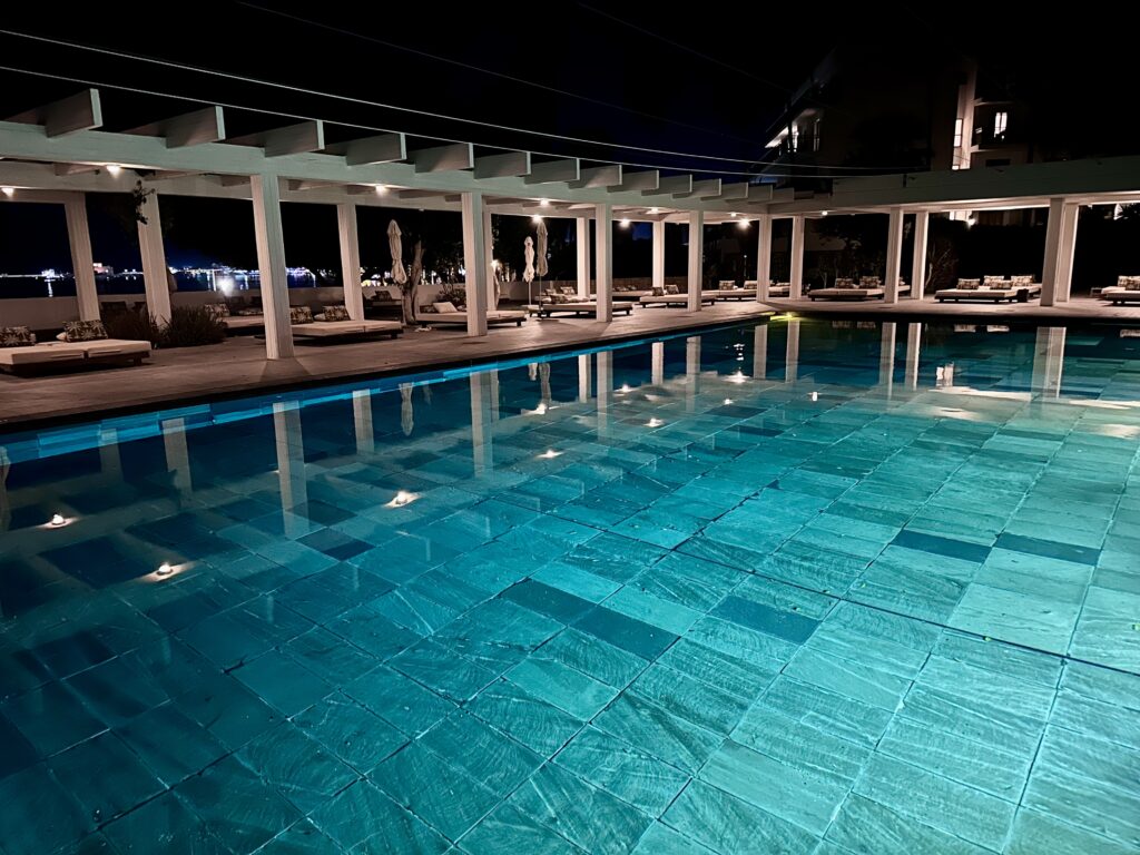 Evening view of the Almyra outdoor swimming pool, a resort in Paphos, Cyprus