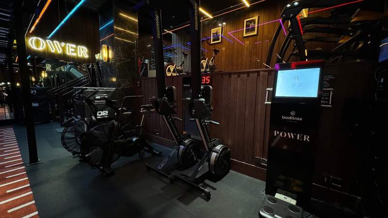 bicycles and a tech machine inside of a dark gym at The Dean Hotel. 
