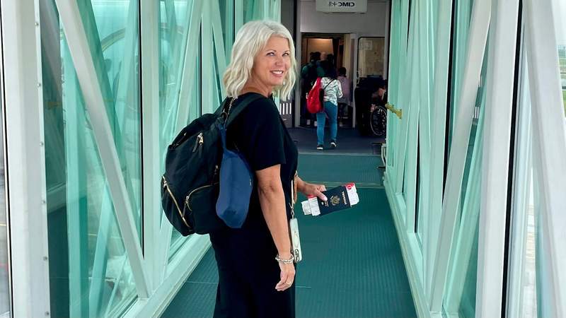 woman boarding a plane with only a small backpack