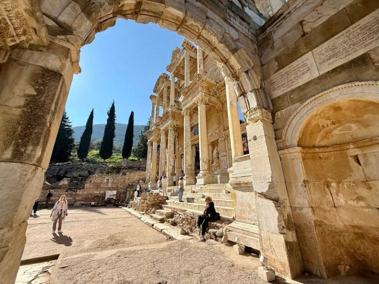 Looking through an ancient archway at the ruins of the front of the Library of Celsus