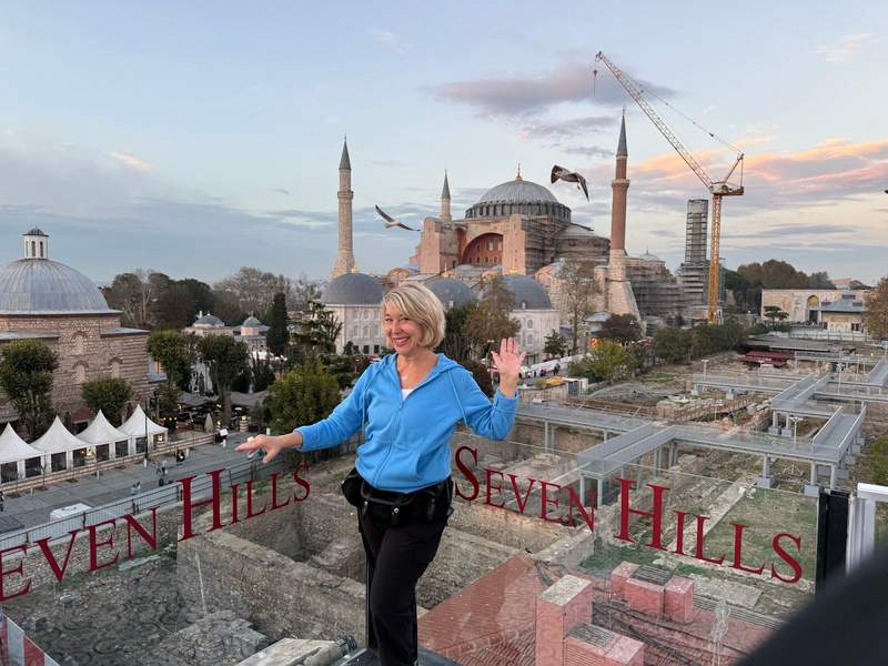 Author posing on a hotel balcony in Istanbul overlooking the Hagia Sophia