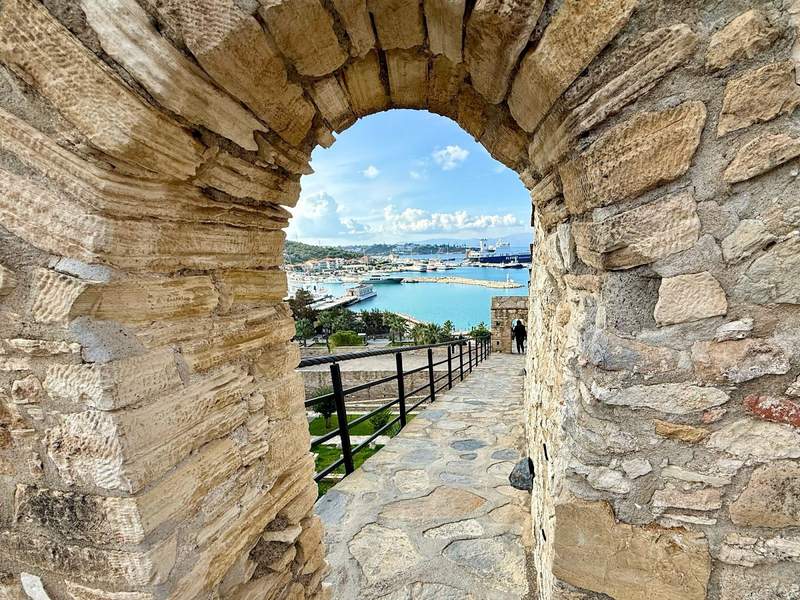 Looking through an ancient stone arch of Cesme castle down to the harbor in Izmir.