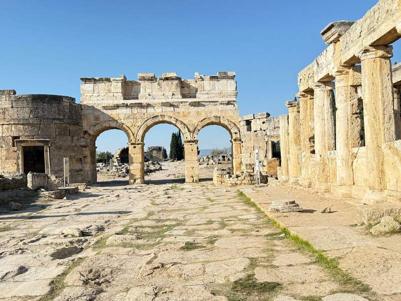 Looking through some arches down a ruined street at the ancient UNESCO World Heritage site, Hierapolis.