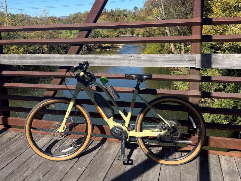 Electric bike parked on a wood and iron bridge overlooking the Roanoke River. 