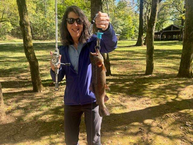 Holding the first catch and release rainbow trout of the day